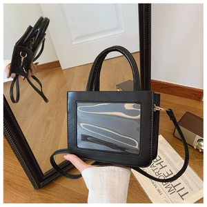Detail view of the black PVC tote bag featuring a clear window for personalization
