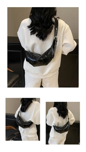 Detail view of black glossy crescent bag with segments stitching and wide strap