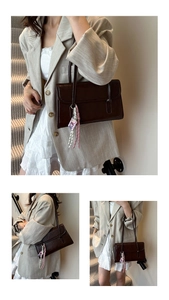 Detail view of a vintage dark brown leather shoulder bag with decorative pendant and flap