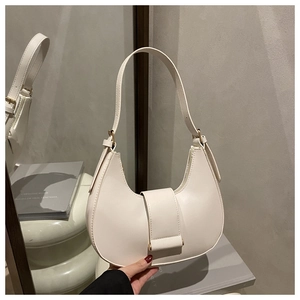 Detail of a creamy white half-moon underarm bag with a smooth PU texture and metal buckle