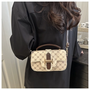Detail of retro floral square bag with gold buckle and adjustable crossbody strap