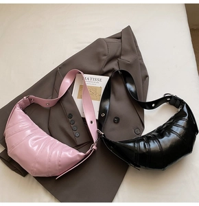 Detail of pink and black quilted oil wax leather crescent bags with wide straps
