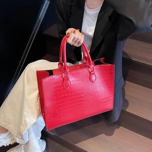 Red crocodile texture large tote bag for women shown with professional attire on stairs