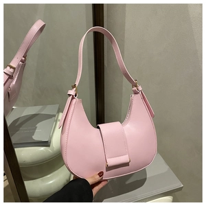 Detail view of pink leather half-moon shoulder bag with adjustable strap and gold buckle