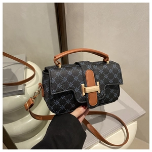 Detail of blue monogram jacquard handbag with brown leather strap and gold H buckle