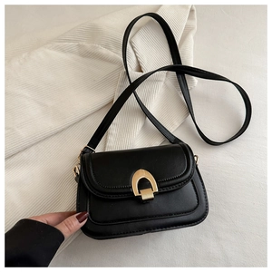 Close-up of black PU leather bag featuring a polished gold horseshoe-shaped twist lock