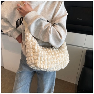 Detail of white puff bubble textured tote bag showing 3D popcorn fabric and soft strap