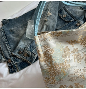 Detail showing Oriental jacquard texture and pavilion patterns on a stylish tote bag