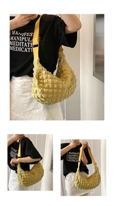 Close-up of yellow textured bubble fabric crossbody bag with adjustable strap and zipper