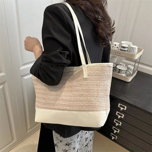 Minimalist woven straw tote bag with white leather base and shoulder straps for women