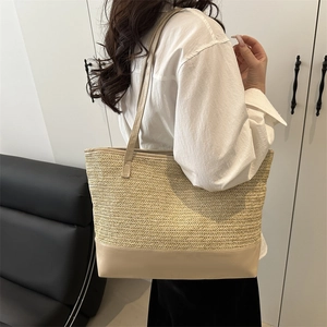 Chic woven straw tote bag with V-pattern stitching and leather handles for summer beach