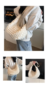 Detail shots of a white pleated cloud bag with textured bubble fabric and wide strap