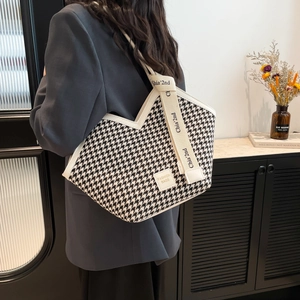 Chic houndstooth tote bag in black and white with wide shoulder strap for women