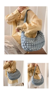 Detail of light blue popcorn texture tote bag showing puffy fabric and crossbody style