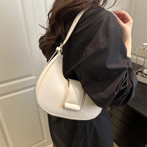 Minimalist beige hobo shoulder bag with a sleek crescent design and flap magnetic closure
