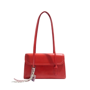 Chic red faux leather shoulder bag with sleek rectangular design and woven strap charm