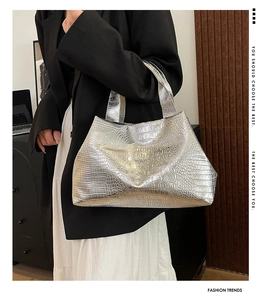 Detail of silver crocodile pattern tote bag showing metallic texture and large capacity