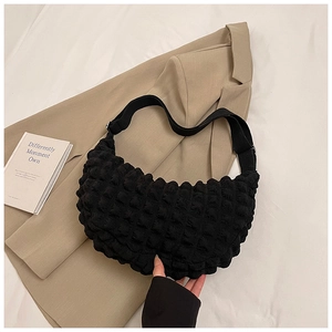 Detail of black hobo bag with bubble texture and adjustable wide fabric strap