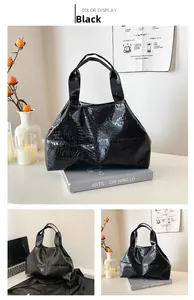 Close-up of black crocodile pattern leather texture and handles on the tote bag