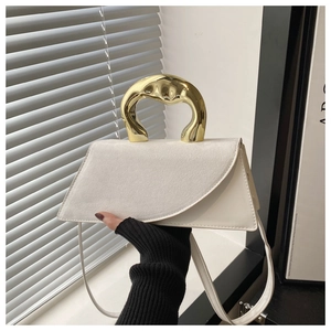 Detail of white leather and suede handbag with artistic gold metal handle