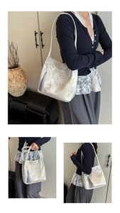 Detail of floral and koi embroidery on cream tote bag with elegant grey tassel