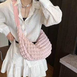 Minimalist light pink textured hobo bag with quilted fabric and woven strap for women
