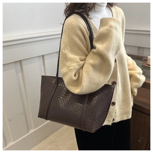 Detail of dark brown woven texture on a large capacity vintage faux leather tote bag