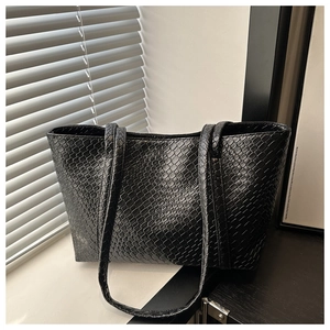 Detail showing the intricate hand-woven texture of the black large capacity tote bag