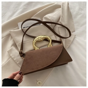 Deep brown suede and leather trapeze handbag with luxury wavy gold metal handle