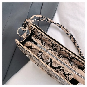 Detailed close-up of snake print faux leather texture with premium silver zipper closure
