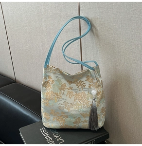 Detail of Chinese style jacquard tote with mountain pattern and grey tassel charm