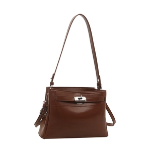 Retro brown leather tote bag with silver buckle and adjustable strap on white background