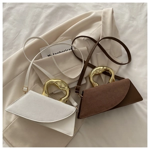 Detailed close-up of premium handbags with liquid metal handles and mixed leather textures