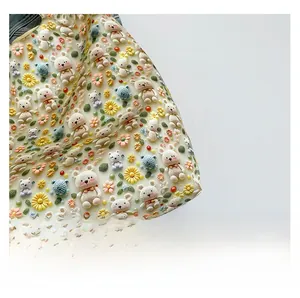 Detail of 3D embossed fabric with crochet style bears and floral patterns