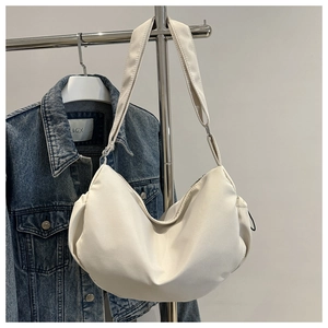 Détail du sac bandoulière blanc en forme de croissant avec tissu lisse et sangle réglable