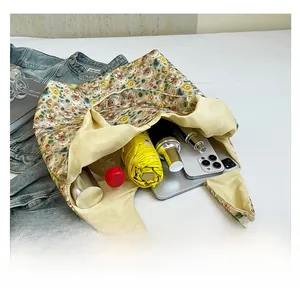 Practical floral tote bag showing large capacity for water bottle, umbrella, and tablet