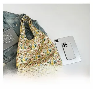 Detail view of beige floral tote bag with 3D teddy bears, daisies and colorful pompoms