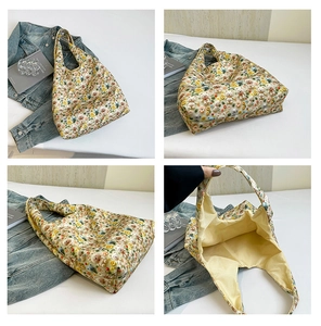 Detailed close-up showing the floral bear embroidery and spacious lining of the tote bag