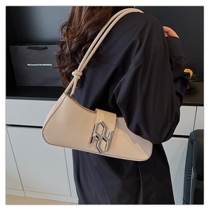Detail of off-white baguette bag featuring silver letter buckle and knotted shoulder straps