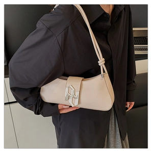 Chic off-white faux leather shoulder bag with metallic buckle shown on shoulder