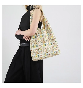 Detail of floral tote bag featuring 3D plush bears and flowers on beige cotton canvas
