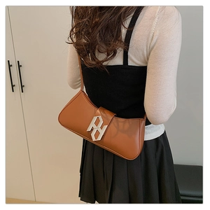 Brown faux leather baguette bag featuring a large silver geometric buckle detail
