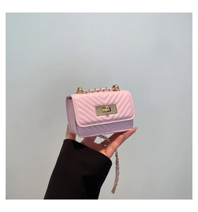 Pink quilted crossbody bag with V-shaped stitching and golden metal chain strap