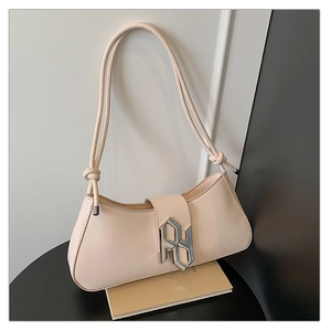 Detail of beige faux leather handbag with geometric metal buckle and knotted strap