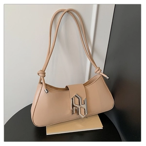 Detail of beige leather shoulder bag with modern silver geometric buckle and knotted strap