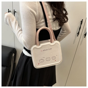 Close-up of a white leather crossbody bag featuring cute cartoon bear prints and pink straps