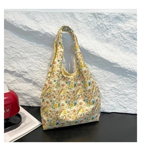 Detail shot of white canvas tote bag with 3D teddy bears and yellow daisy floral patterns