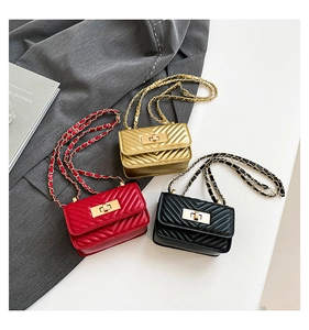 Close-up of V-shaped quilted crossbody bags with chain straps in gold, red and black