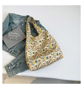 Close-up of floral embroidery with 3D plush bears and daisies on a canvas tote bag