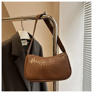 Close-up of the dark brown woven leather texture and intricate Intrecciato craftsmanship